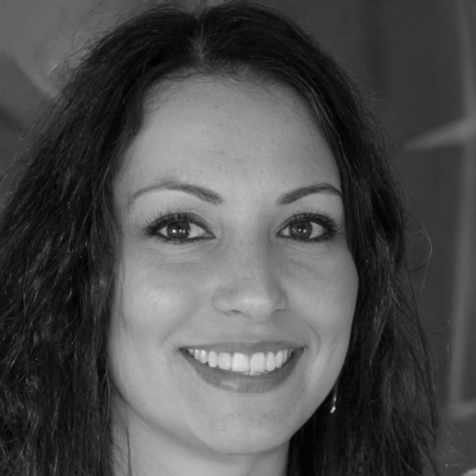 Professional headshot of team member in office environment
